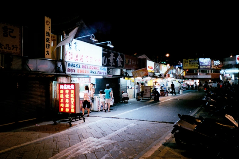 a city street is crowded with shops on either side