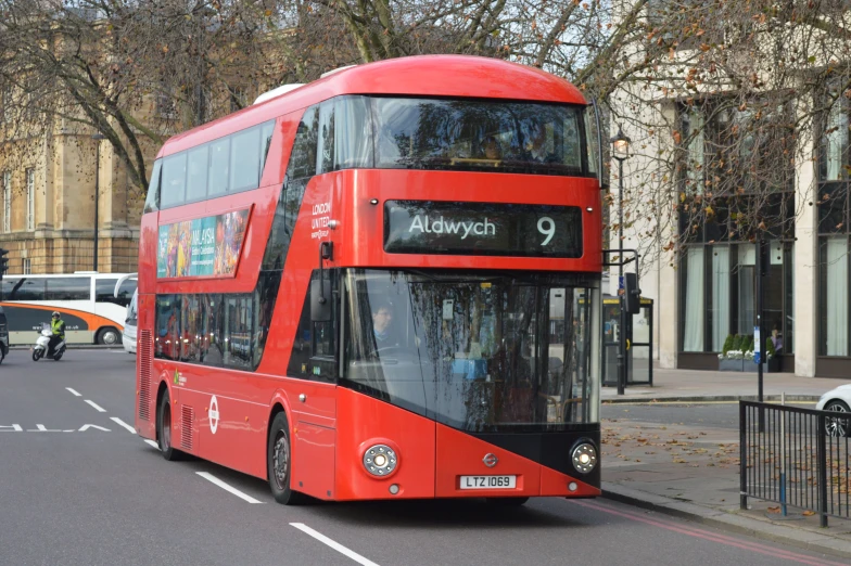 a red double decker bus in the middle of the road