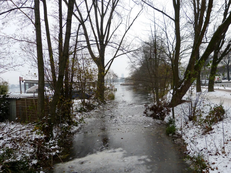 a river flows past a bridge on a snowy day