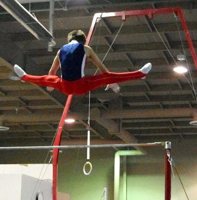 woman doing aerial exercises in indoor gym