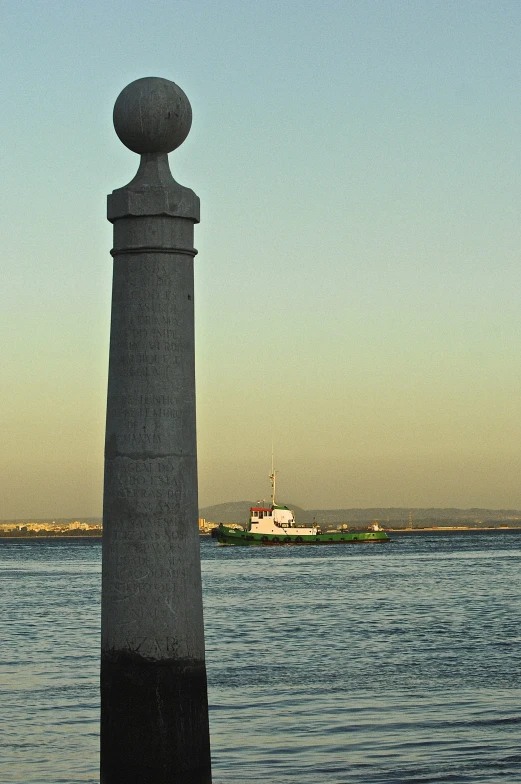 an old concrete pole is standing in the water