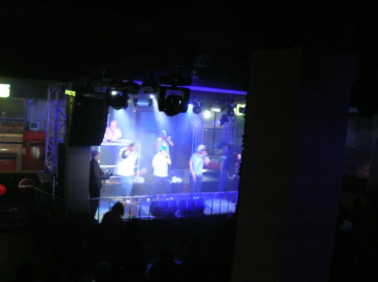 a group of people standing on top of stage