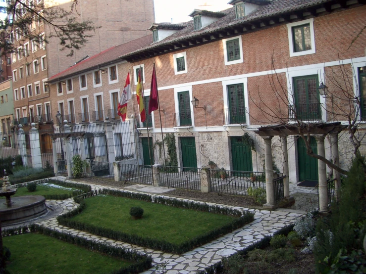 a small garden in front of several buildings