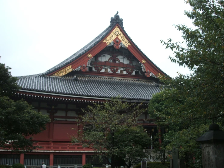 tall, elaborate asian style building surrounded by greenery