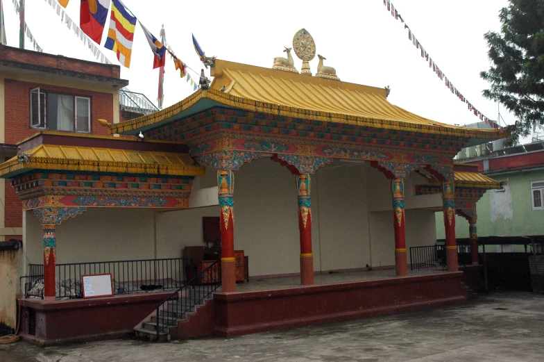 an old building with two flags above it