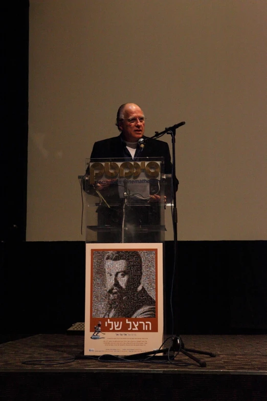 a man wearing a suit and tie speaking