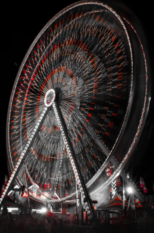 a large ferris wheel at a fair that is red