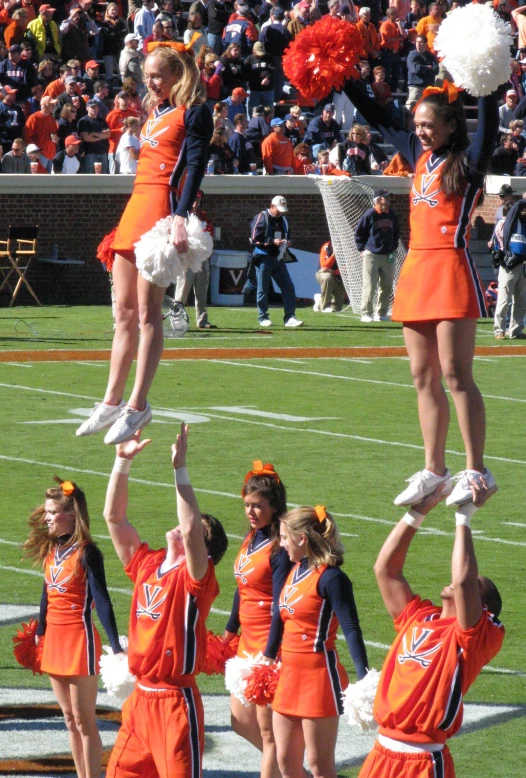 a cheerleader performs for the crowd at the football game