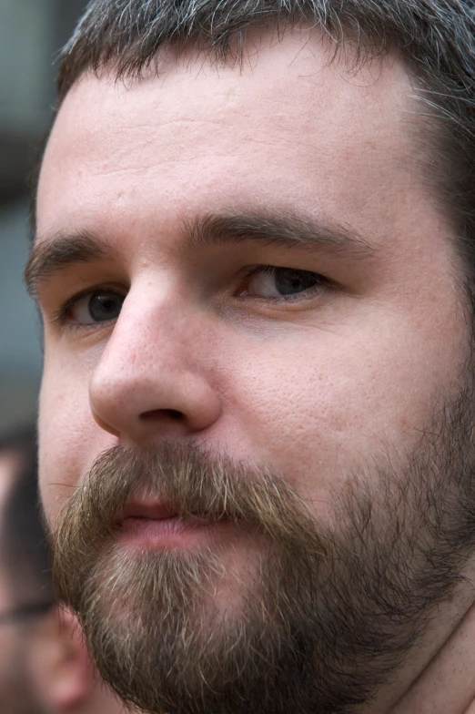 a man with a beard and a tie in his hand