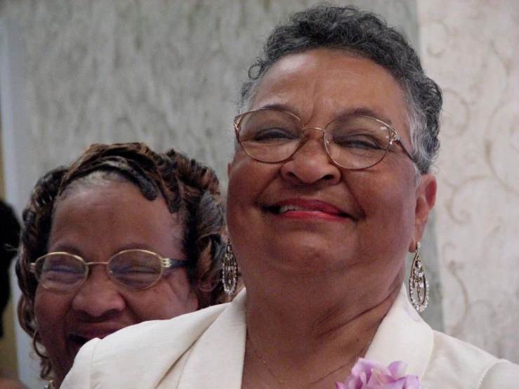 two women are all smiling for the camera