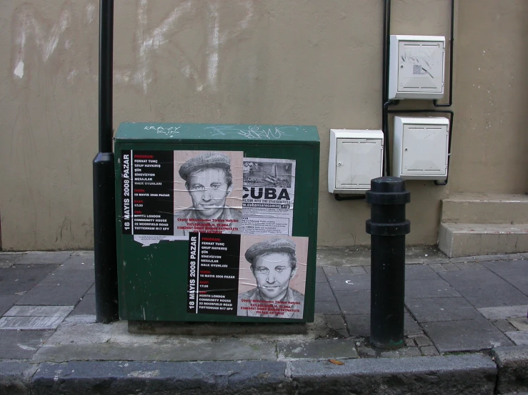 newspaper and box on the side of a building