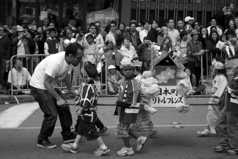 a man is leading children across the street