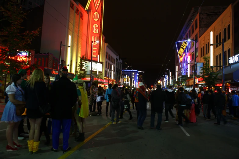 a group of people on a street at night