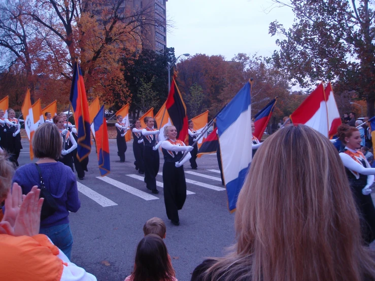 people are marching in the street holding flags