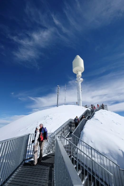 a man hiking up the stairs to a television antenna