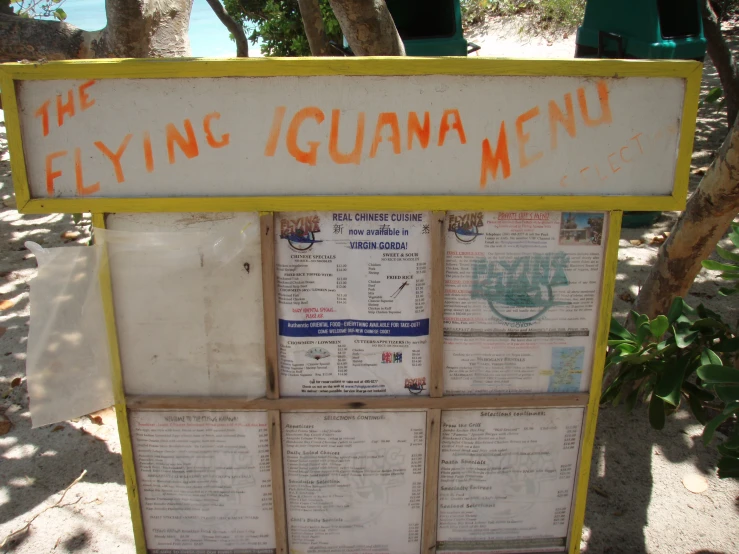 a menu board sitting in the middle of a tree