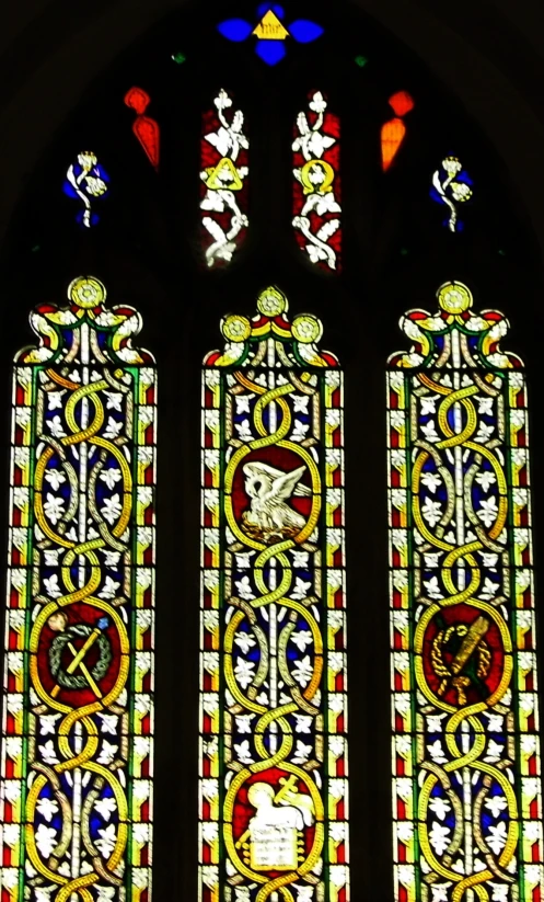 a stained glass window shows religious symbols