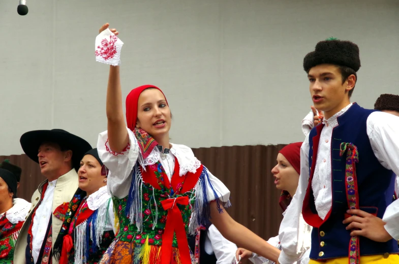 people in polish traditional costume holding a juggling drum