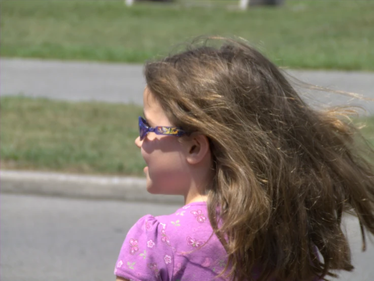 a small girl with shades and a hair dryer