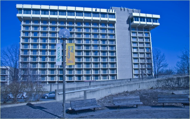 a building and sign stand in front of a city street