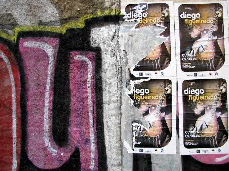 a display of flyers and a wall with graffitti