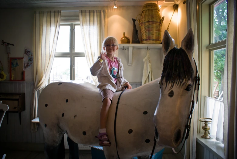 a  riding a big horse statue in a house