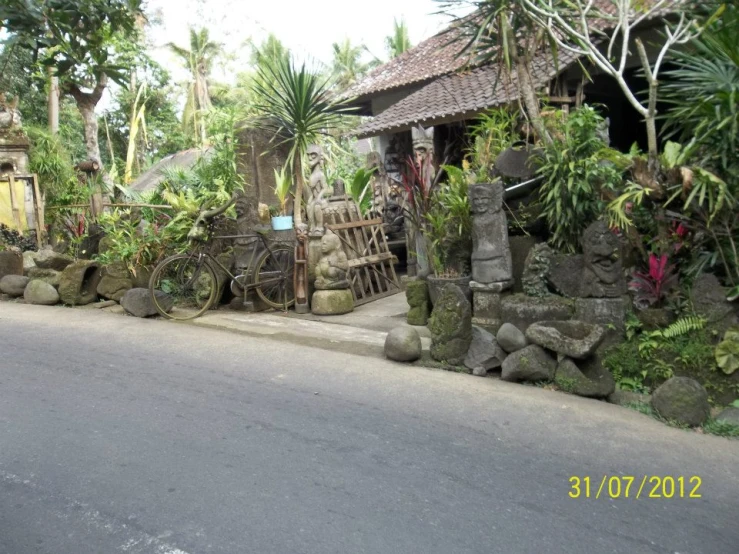 a stone wall next to a road and trees