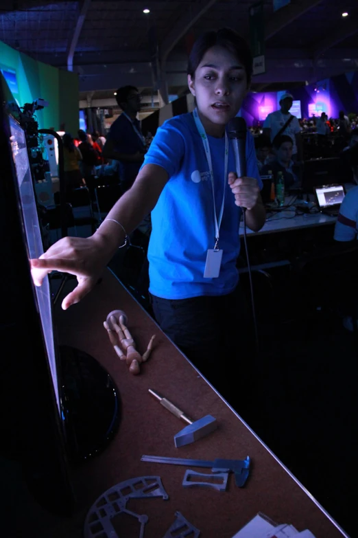 a woman at a table with several items displayed