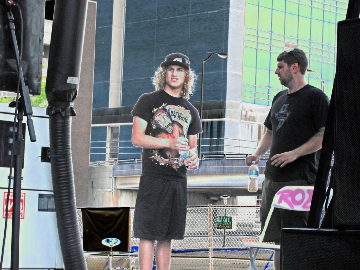 a person standing on a stage holding a glass