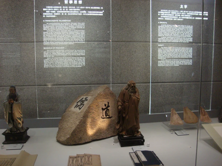 a display area features sculptures, religious texts and a rock
