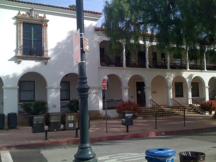 a street lamp standing in front of a white building