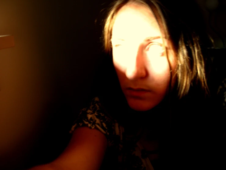 a woman looking directly into the camera with a shadow