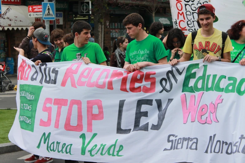 a group of people holding a banner at a protest