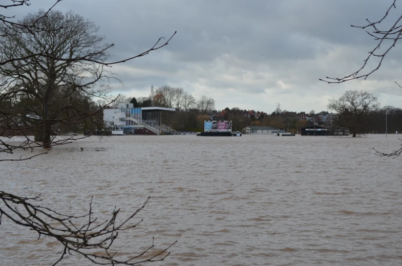 water covering a park in front of a white building