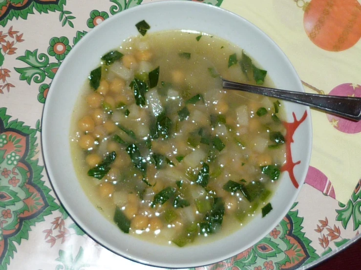 a bowl of soup sits on a placemat