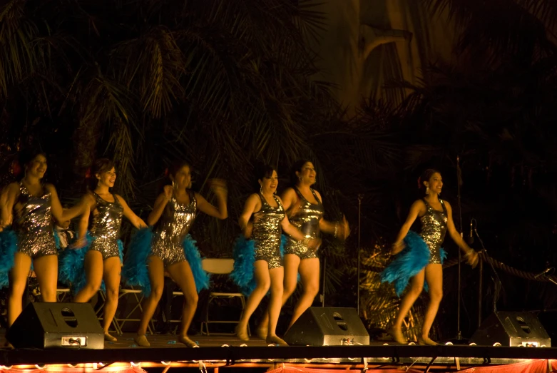 a group of women dressed in costume are dancing