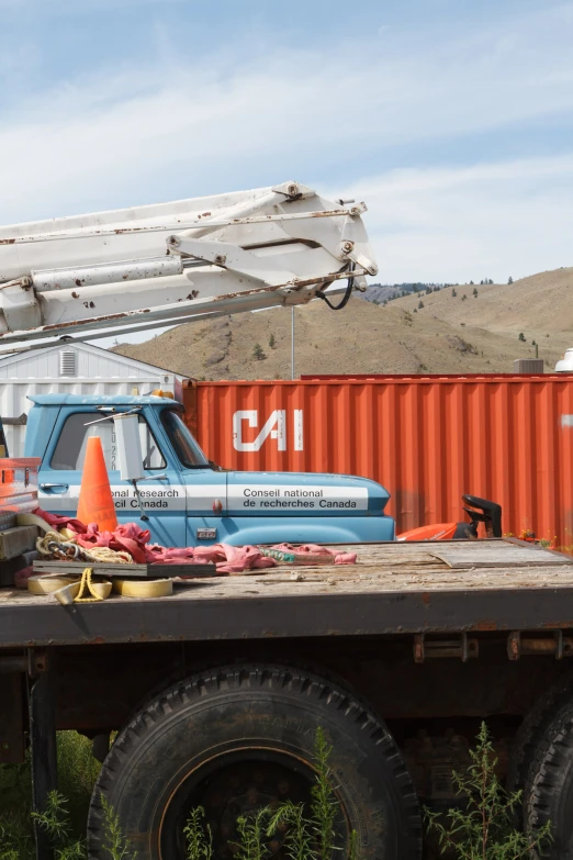 a flatbed truck with some construction equipment on top of it