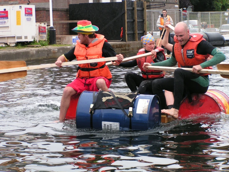 several people in life jackets on a small raft