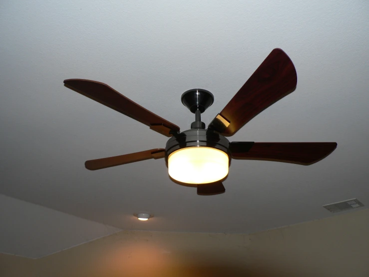 a ceiling fan with wooden blades and lights