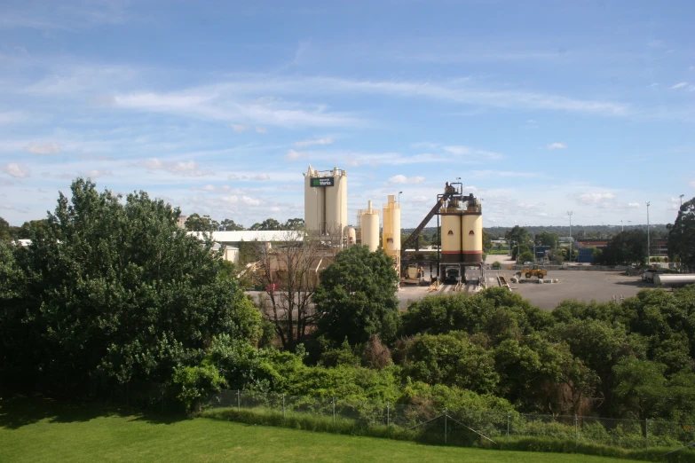 there are many big grain silos in the parking lot