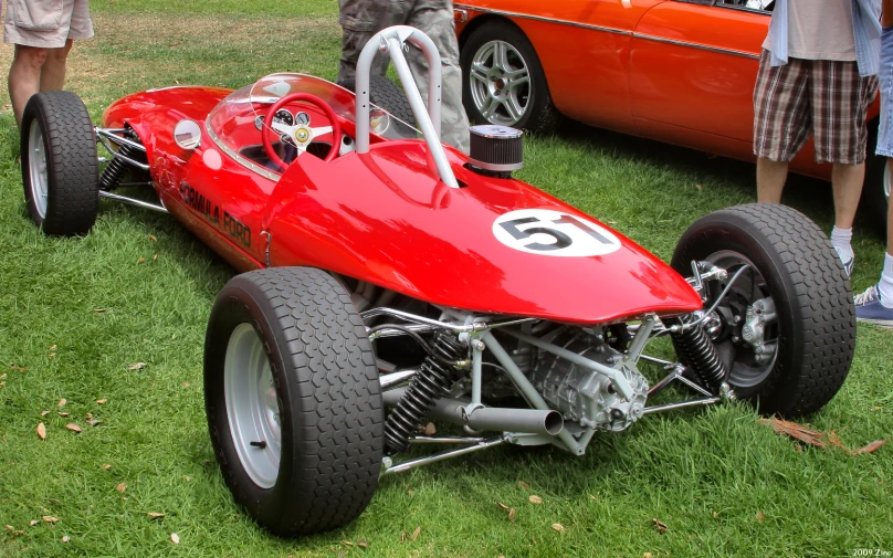 there is a red race car with a number on the front wheel