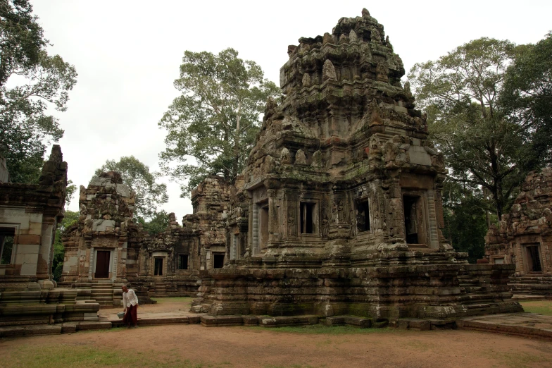 a stone building with some people on it