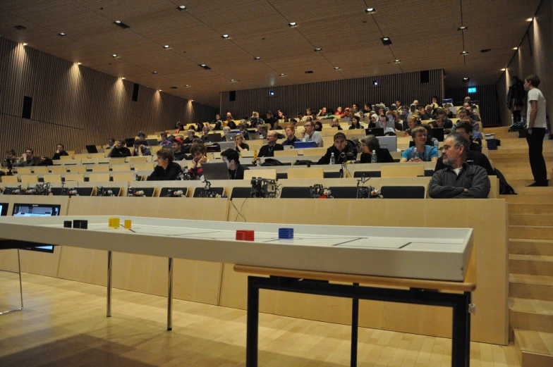 there is a very large lecture hall with rows of people