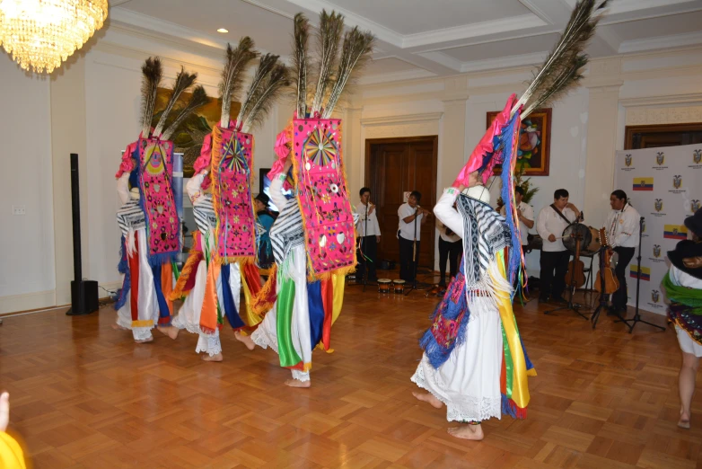 a group of women dancing on a wooden floor