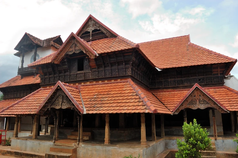 an intricate wooden building with a clock tower at the top