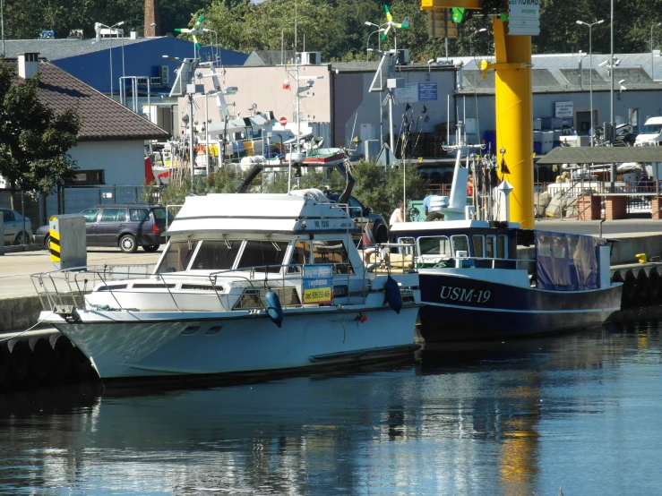 two boats sit at the dock of a small harbor