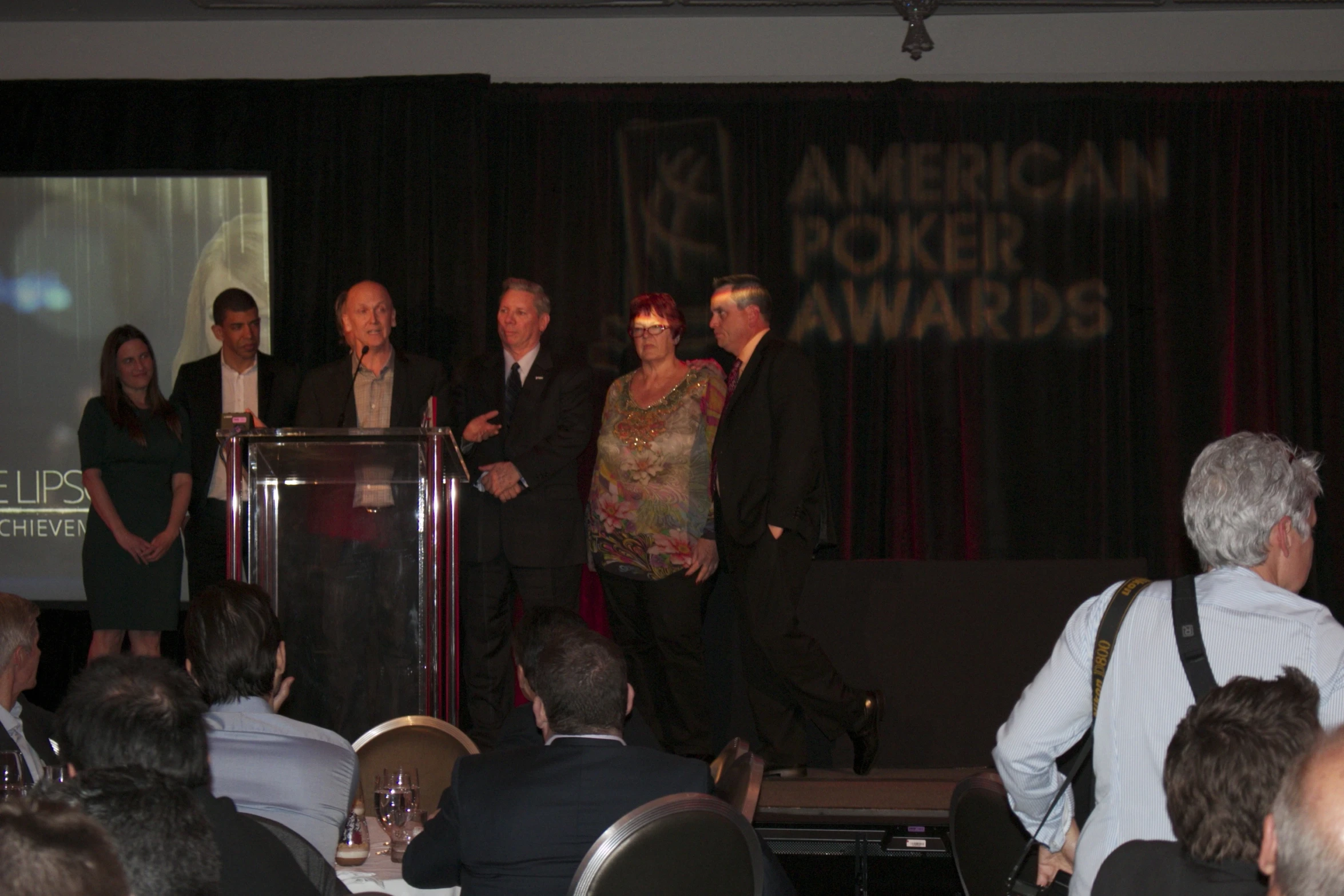 a group of people standing on stage at awards