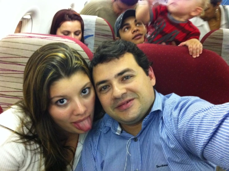 a man and woman are posing with their tongue out