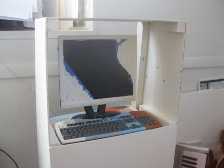a broken computer with a blank screen and keyboard