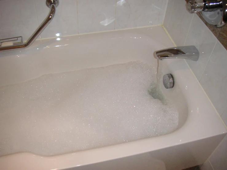 a bath tub filled with bubbles of white water